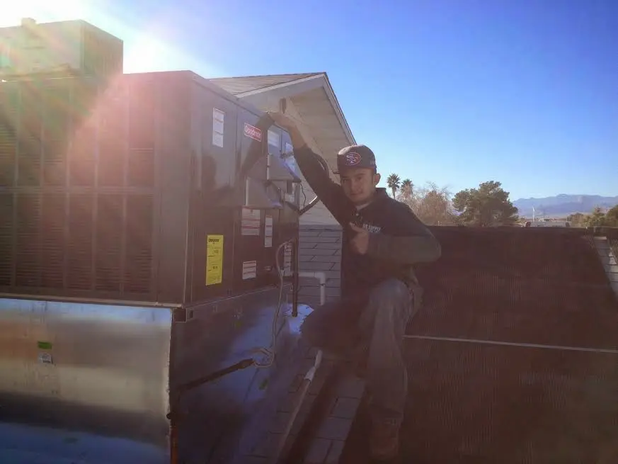 HVAC technician performing AC Tune-Up on a rooftop unit in Pottstown